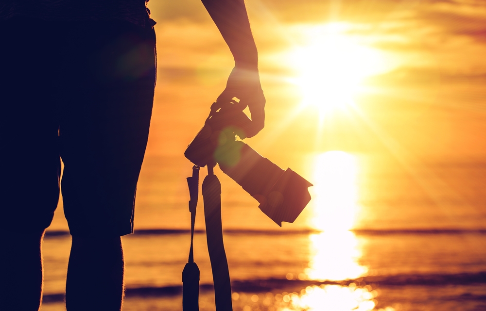 Photographer facing sunset