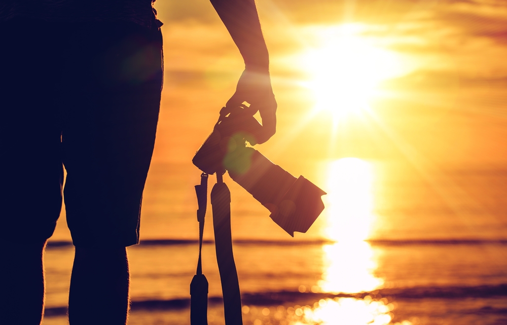 Photographer facing sunset