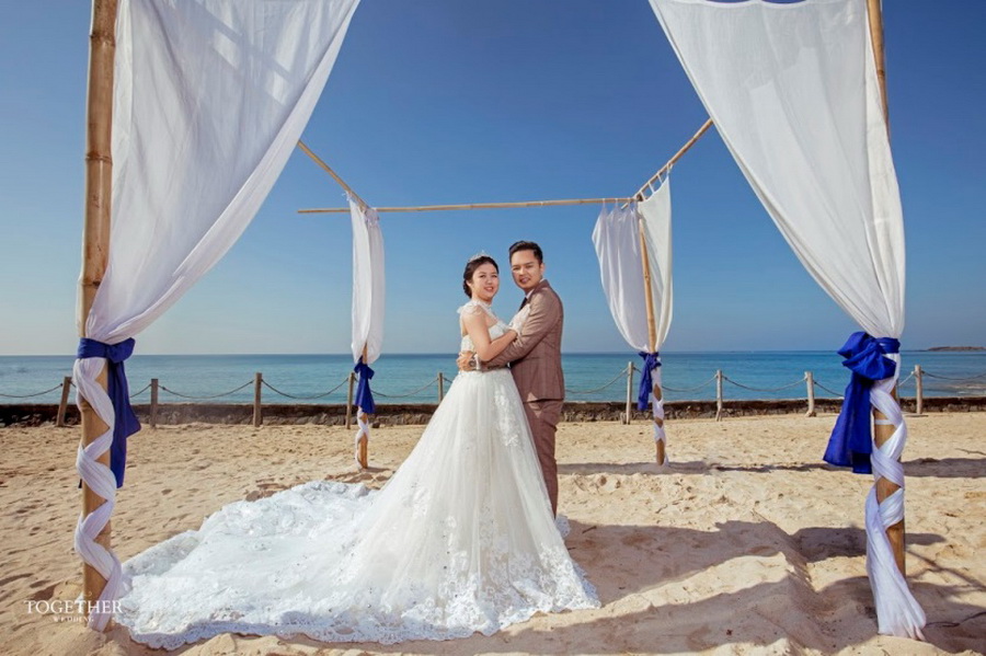 Bride and groom share vows on the beach at Hilton Ngapali 