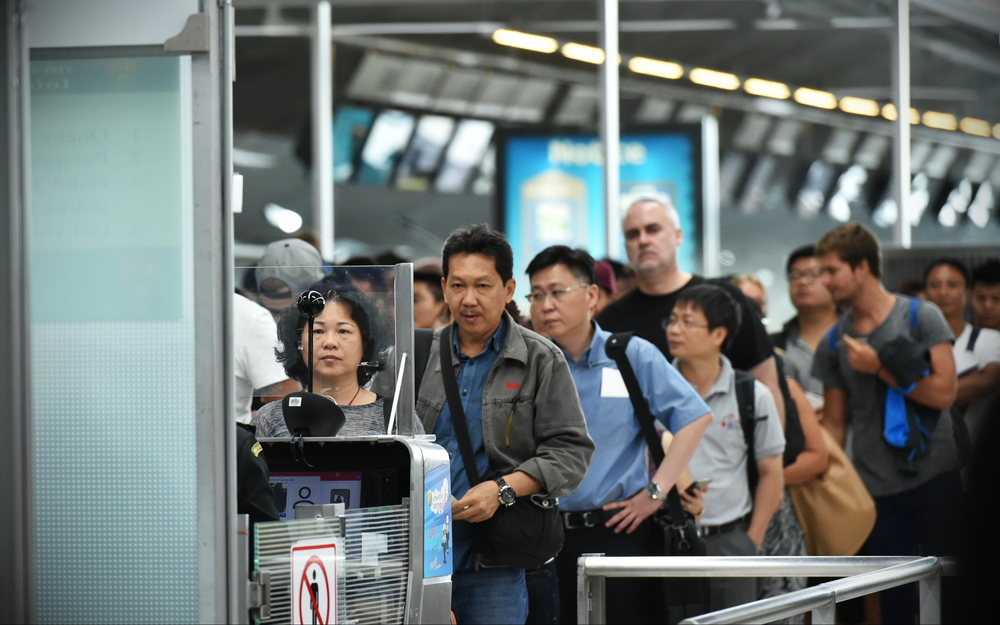 Passengers queue at immigration control at Suvarnabhumi International Airport