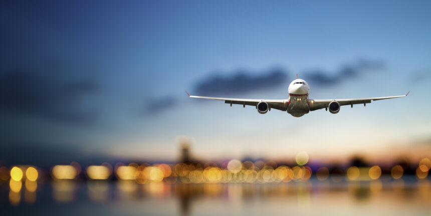 Perspective,View,Of,Jet,Airliner,In,Flight,With,Bokeh,Background