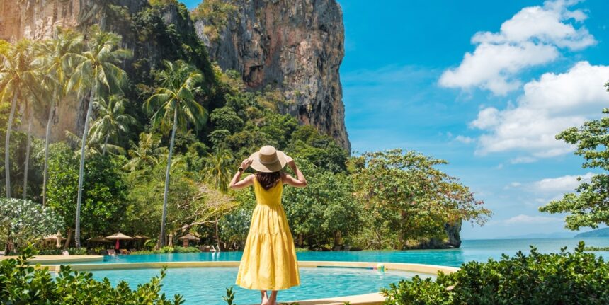 Woman,Tourist,In,Yellow,Dress,And,Hat,Traveling,On,Railay